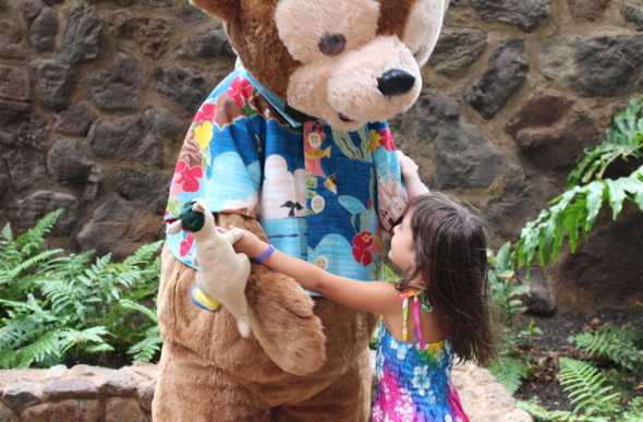 A young girl embraces the character of Duffy the Disney Bear at Aulani