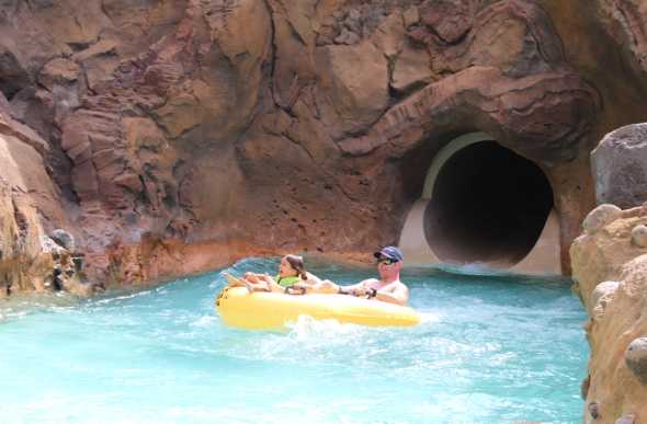 A father and daughter on a tube in the water park at Disney Aulani Resort on Oahu