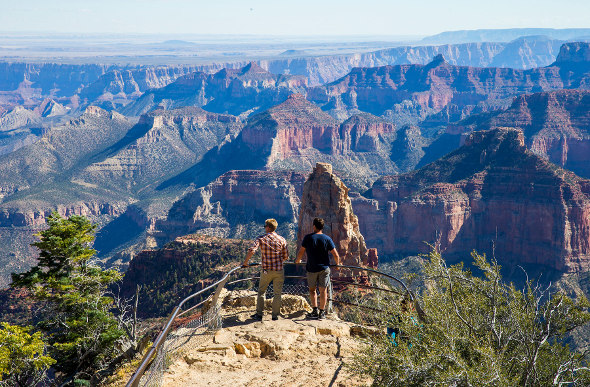 Two men look out from one of the scenic lookouts at Grand Canyon National Park