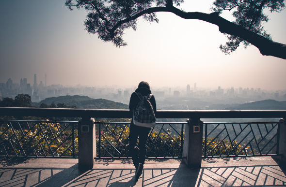 A female tourist admires the cityscape of Guangzhou in China