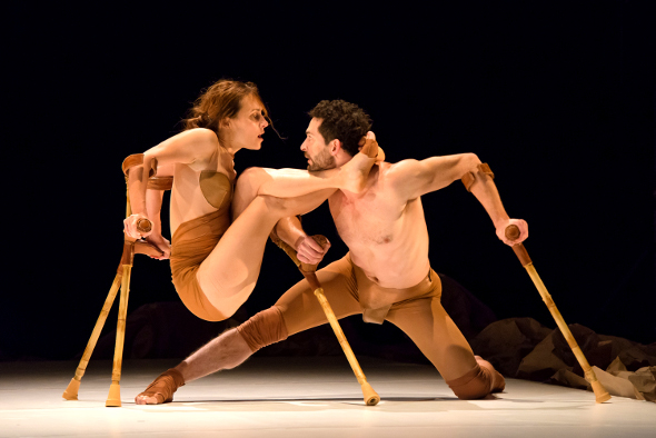 man and woman dancing on stage with crutches