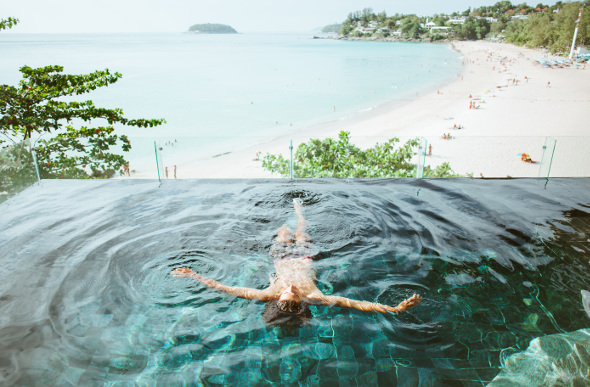 Man swimming in an infinity pool within The Shore at Katathani resort in Phuket