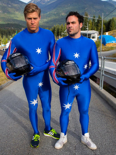 TV hosts Miguel Maestre and Chris Brown wear Lycra suits emblazoned with the Australian flag for bobsledding
