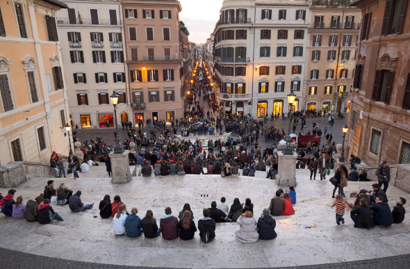 A stunning view of Piazza di Spagna in Rome from the Spanish Steps at dusk with lots of people in the area