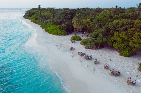 An aerial view of the beachside dining at By the Beach at Soneva Fushi