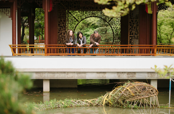 People look into a lake at Dr Sun Yat-Sen Classical Chinese Garden in Vancouver