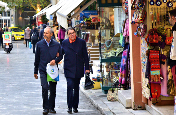 A couple walking past the market stalls in Plaka