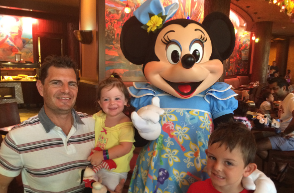 A family posing for photo with Minnie at Aulani, A Disney Resort & Spa