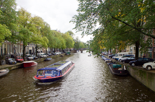 A boat cruising down Amsterdam's canal