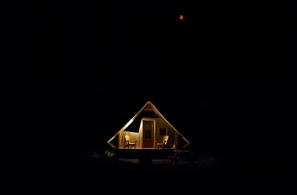 A peaceful 'oTENTik' tent cabin at night in the Banff national park.