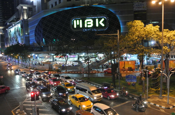 Cars driving past the MBK shopping mall in Bangkok