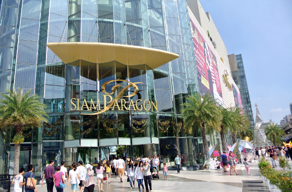 The stylish exterior facade of Siam Paragon with people outside