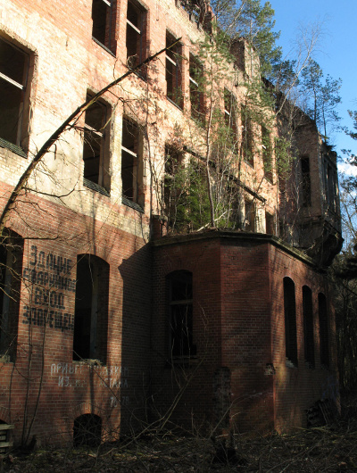 Stained brick exterior of abandoned hospital