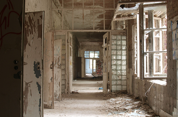 Ruined hall and smashed windows in abandoned hospital