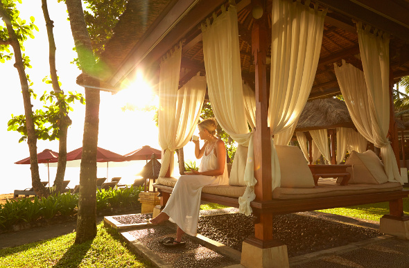 Woman sitting on a luxury bungalow in Bali