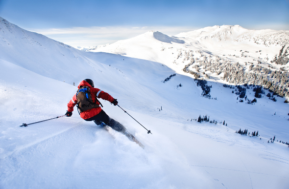Skier cruising down a slope at Whistler