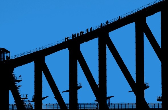 Silhouette of climbers at dawn on the Sydney Bridge Climb.