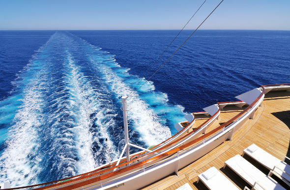 View of wake in the water from the back of a cruise ship