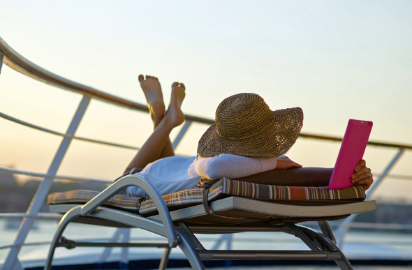 Woman reading on a lounger on a cruise ship