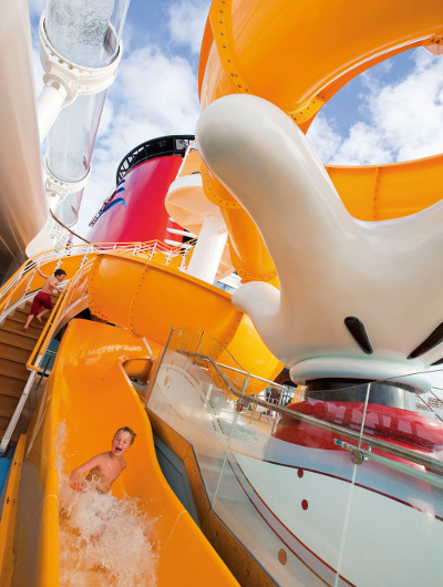 Kid sliding down a water slide