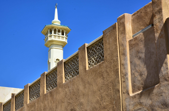 A minaret looms above the low-rise area of Al-Fahidi