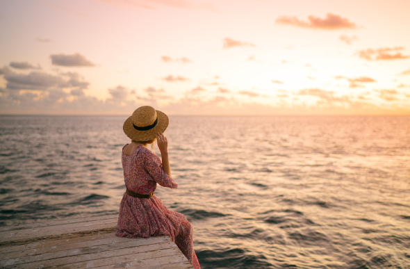 Emilie Ristevski watches the sunset at Hardy Reef from the Reefworld pontoon in the Whitsundays.