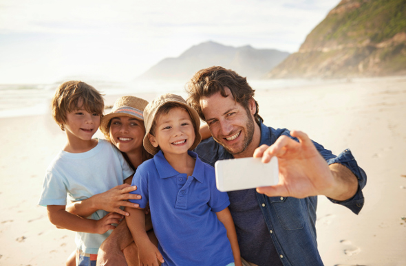 Family taking a selfie on the beach