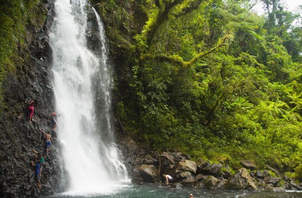 Fiji locals climbing a waterfall