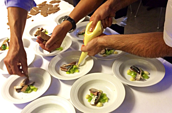 Chefs plate up mackerel in Copenhagen, Denmark.