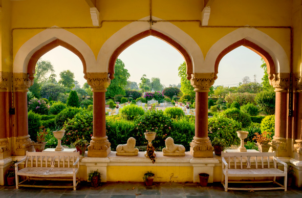 A Yellow balcony looking out over a green garden