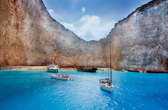 Boats moored in a private cove with shipwreck