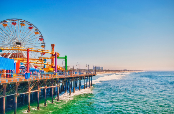 A Ferris wheel and amusement rides at Santa Monica pier, Los Angeles.