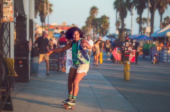 A woman rides a skateboard in Venice Beach, Los Angeles.