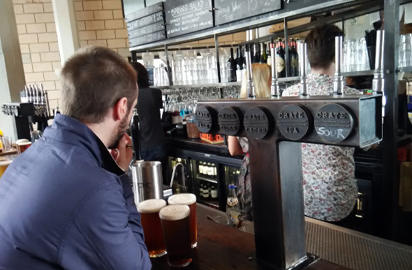 A man ordering pints of craft beer at Crate Brewery