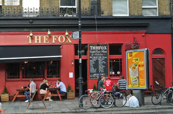 People sitting outside The Fox craft beer bar in London