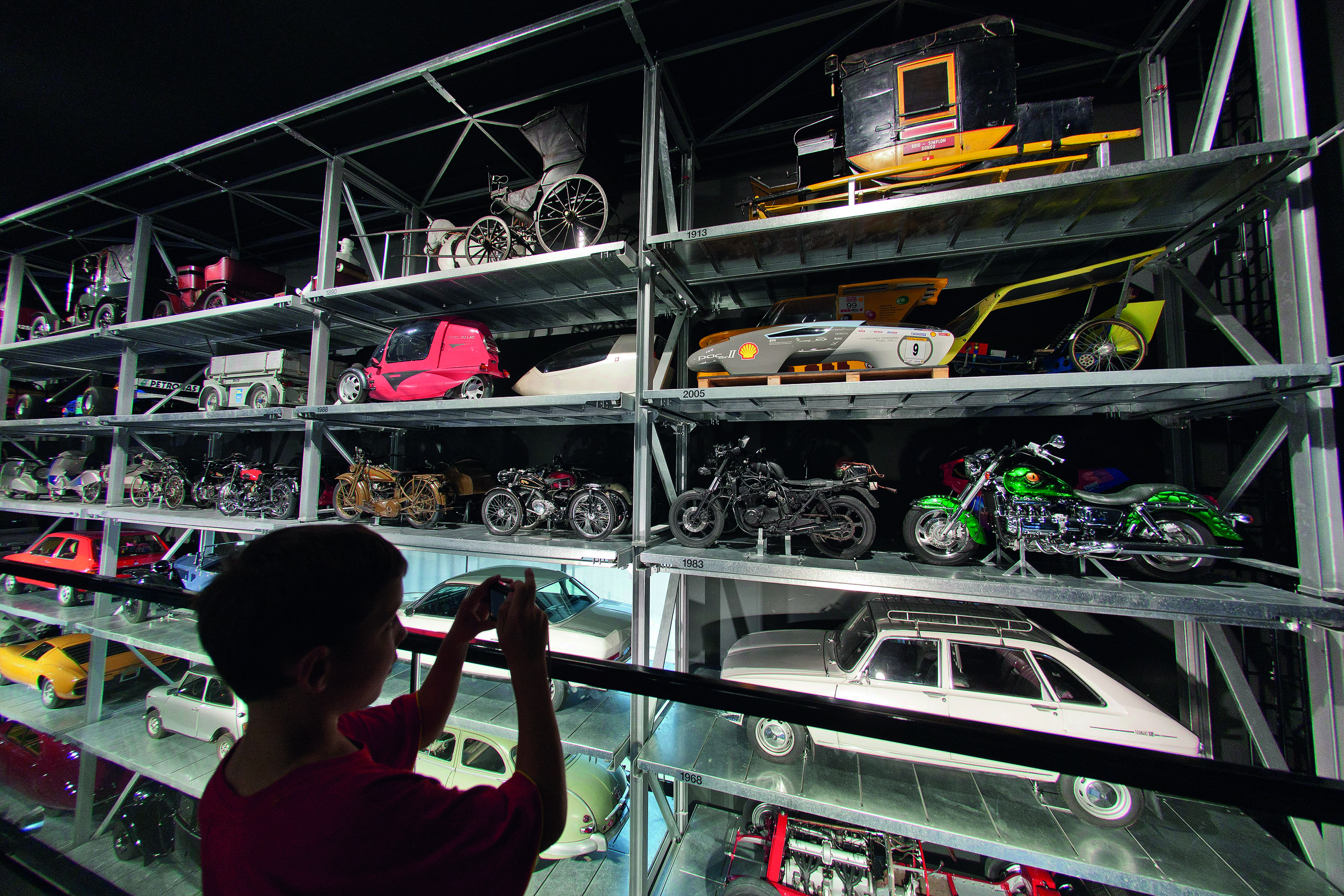 A child admires toy cars at the Swiss Museum of Transport.