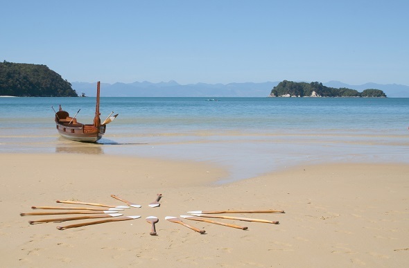 A Waka Māori watercraft moored on a beach.
