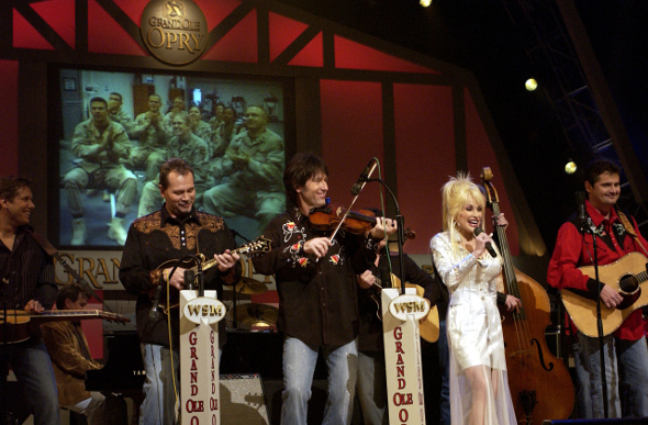 Dolly Parton performing on stage at the Grand Ole Oprey