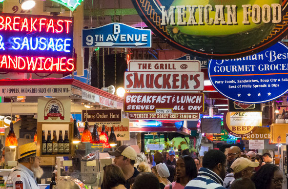 Signs jostle for position at Reading Terminal Market in Philadelphia.