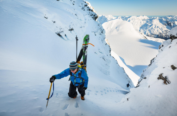 A snowboarder hikes up a snowy mountain in a scene from the New Zealand Mountain Film & Book Festival.