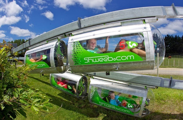 Kids having fun in the Shweeb racing pods.