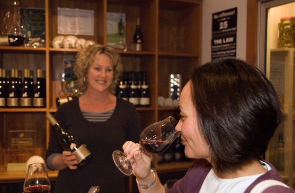 A woman tastes wine at a cellar door in Marlborough, New Zealand.