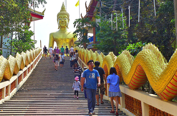 Stairs leading up to a giant golden Buddha