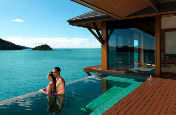  Couple looking out from infinity pool into Whitsundays