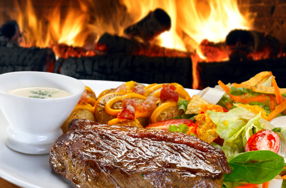 A picanha steak served by a roaring fire in Brazil.