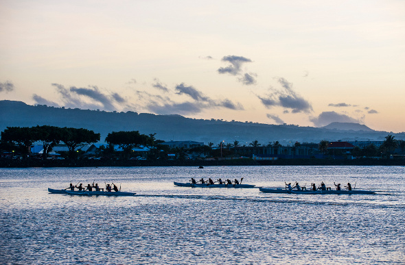Rowers cruising along the water in Apia