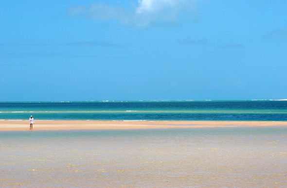 A woman walks the beach on Bazaruto Island.
