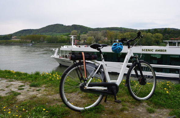 A motorised bicycle sits beside the Scenic Amber in Europe.