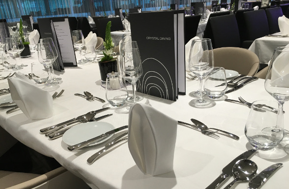 Peruse the a la carte menu at Crystal dining on board Scenic Amber.