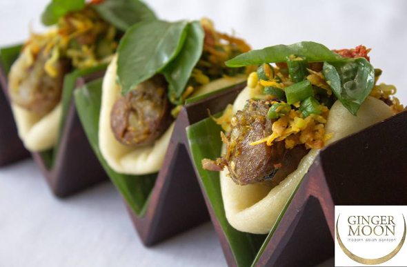 Three meat-filled buns in a wooden holder